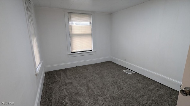 916 6th St NW, Canton, OH 44703 - spare room with dark carpet and plenty of natural light