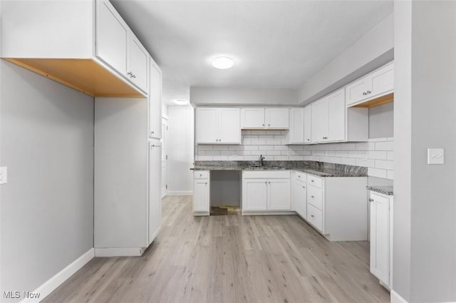 5318 Pinecrest Ave, Youngstown, OH 44515 - kitchen featuring backsplash, light wood-style floors, and white cabinets
