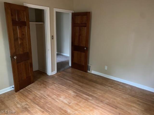 1543 Genesee Rd, South Euclid, OH 44121 - unfurnished bedroom with light wood-type flooring and a closet