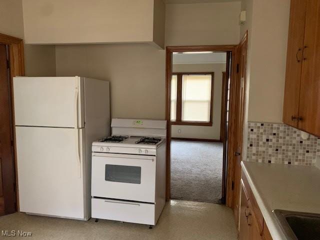 1543 Genesee Rd, South Euclid, OH 44121 - kitchen with white appliances, light colored carpet, and light countertops