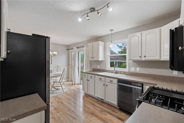 7287 Fayette Blvd, Chippewa Lake, OH 44215 - kitchen with appliances with stainless steel finishes, white cabinets, a textured ceiling, light wood-type flooring, and light countertops