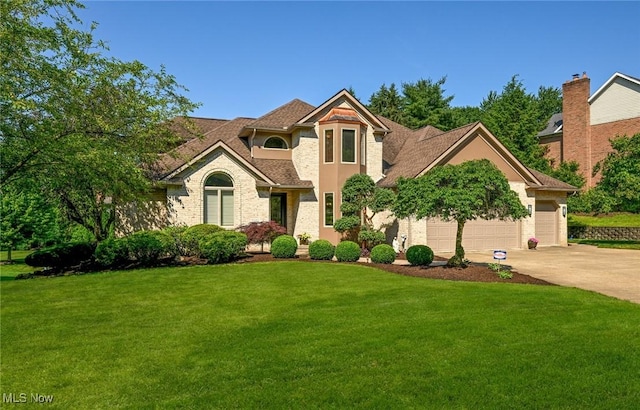 5277 Foxchase Ave NW, Canton, OH 44718 - mediterranean / spanish-style home featuring driveway, a front lawn, and a garage