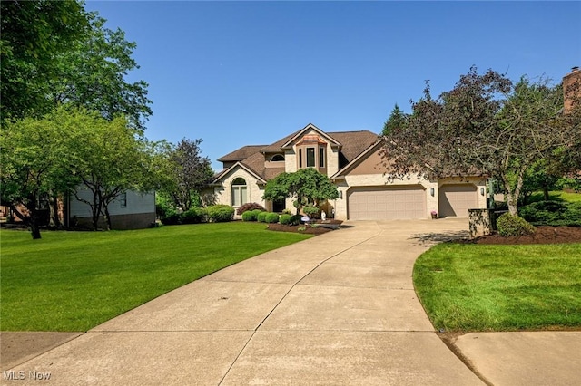 5277 Foxchase Ave NW, Canton, OH 44718 - view of front facade with concrete driveway, an attached garage, a front lawn, and stucco siding
