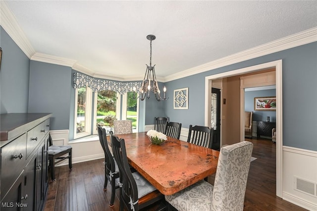 5277 Foxchase Ave NW, Canton, OH 44718 - dining space with dark wood-type flooring, a chandelier, ornamental molding, and a wainscoted wall