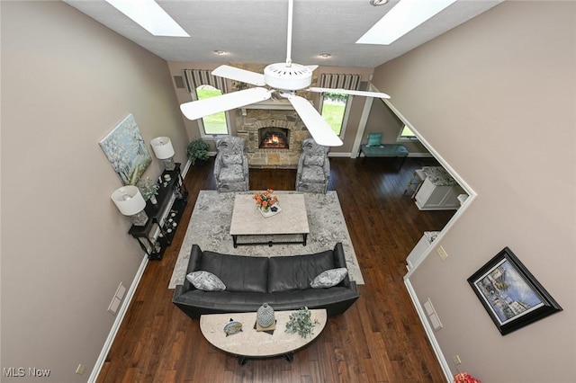 5277 Foxchase Ave NW, Canton, OH 44718 - living room with a skylight, wood finished floors, a fireplace, and vaulted ceiling