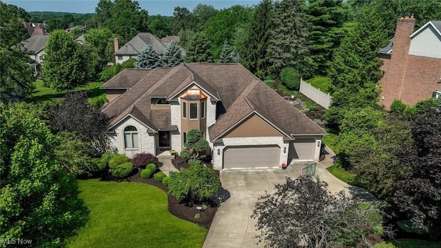 5277 Foxchase Ave NW, Canton, OH 44718 - view of front of property with a garage, driveway, a front yard, and roof with shingles