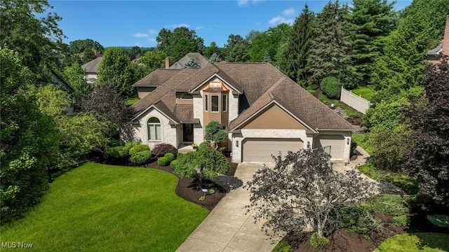 5277 Foxchase Ave NW, Canton, OH 44718 - traditional home featuring a garage, a front lawn, concrete driveway, and a chimney