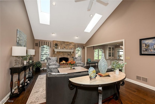 5277 Foxchase Ave NW, Canton, OH 44718 - living area featuring a skylight, high vaulted ceiling, a stone fireplace, dark wood finished floors, and recessed lighting
