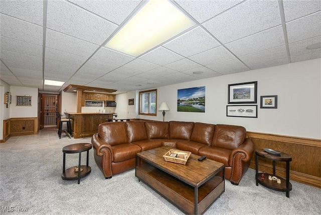 5277 Foxchase Ave NW, Canton, OH 44718 - living room with wet bar, light colored carpet, a paneled ceiling, and a wainscoted wall