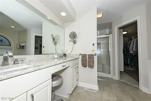 5277 Foxchase Ave NW, Canton, OH 44718 - bathroom featuring a walk in closet, double vanity, a shower stall, and recessed lighting