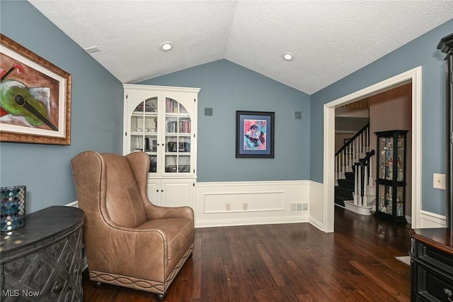 5277 Foxchase Ave NW, Canton, OH 44718 - sitting room with lofted ceiling, a textured ceiling, wood finished floors, stairs, and a wainscoted wall