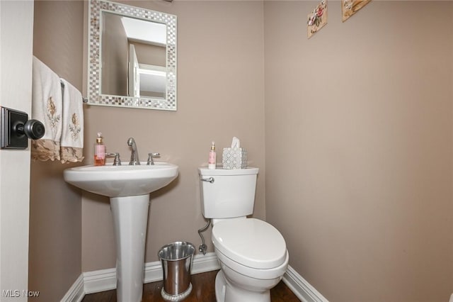 5277 Foxchase Ave NW, Canton, OH 44718 - half bathroom featuring toilet and wood finished floors