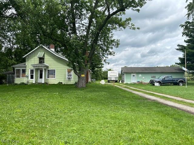 17880 State Route 62, Beloit, OH 44609 - view of side of home featuring a lawn and a chimney