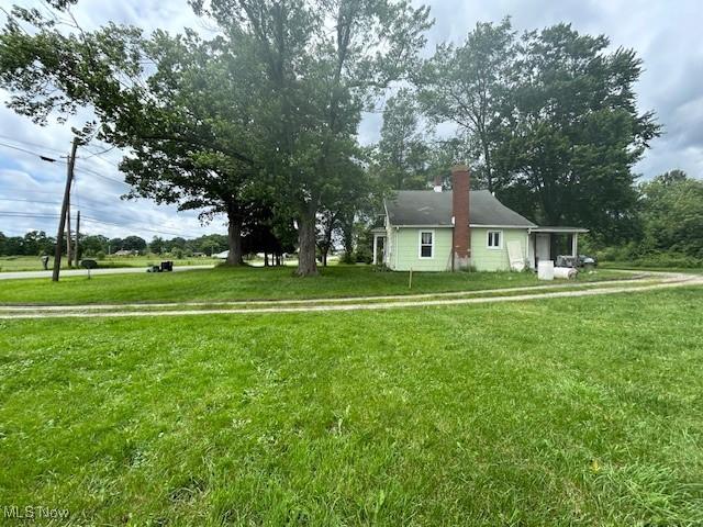 17880 State Route 62, Beloit, OH 44609 - view of home's exterior with a yard and a chimney