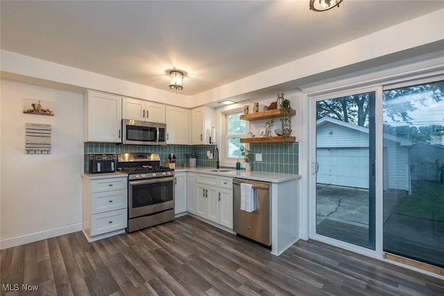 29123 Homewood Dr, Wickliffe, OH 44092 - kitchen featuring stainless steel appliances, light countertops, dark wood-style flooring, backsplash, and open shelves