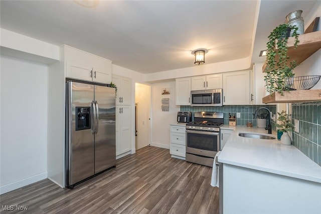 29123 Homewood Dr, Wickliffe, OH 44092 - kitchen featuring appliances with stainless steel finishes, light countertops, white cabinets, tasteful backsplash, and dark wood-style flooring