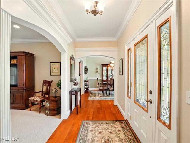 4440 Rutledge Ave, Ashtabula, OH 44004 - foyer entrance featuring arched walkways, ornamental molding, and light wood-style floors