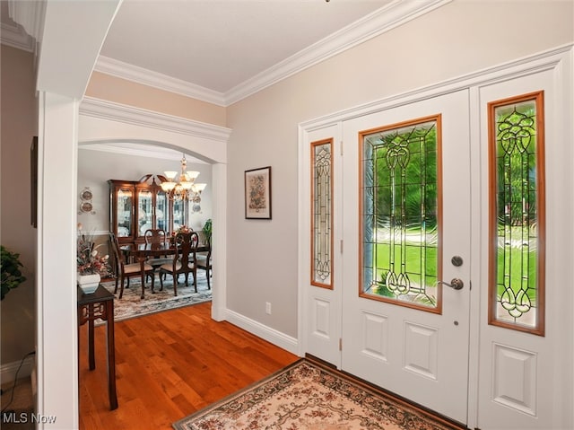 4440 Rutledge Ave, Ashtabula, OH 44004 - entryway with a chandelier, crown molding, wood finished floors, and arched walkways