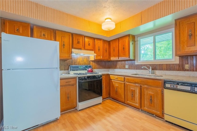 34112 Chagrin Blvd Unit 7106, Moreland Hills, OH 44022 - kitchen with white appliances, under cabinet range hood, brown cabinets, and light wood-style floors