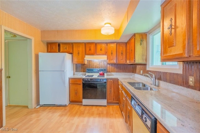 34112 Chagrin Blvd Unit 7106, Moreland Hills, OH 44022 - kitchen featuring white appliances, under cabinet range hood, brown cabinets, light wood finished floors, and light stone counters