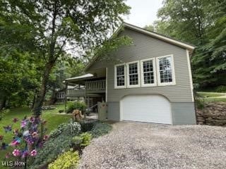 2461 Trailwood Dr SW, Carrollton, OH 44615 - view of side of property featuring driveway, a garage, and a deck