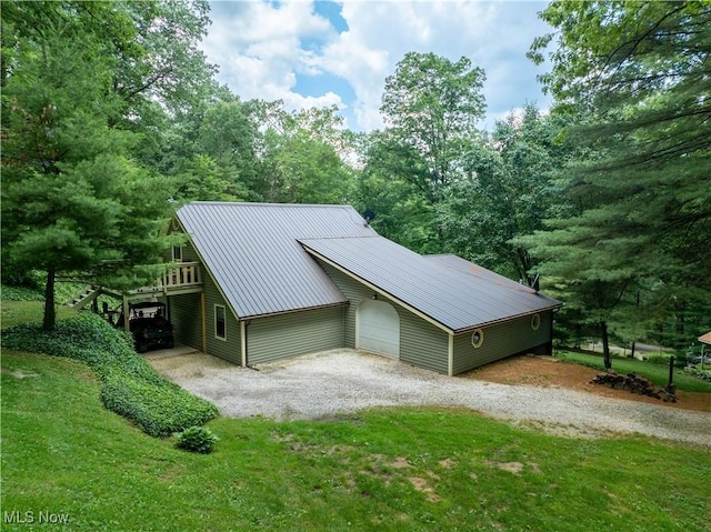 2461 Trailwood Dr SW, Carrollton, OH 44615 - view of side of home featuring a metal roof, a yard, and a detached garage