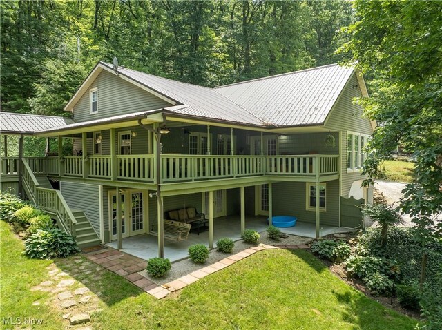 2461 Trailwood Dr SW, Carrollton, OH 44615 - back of house featuring a patio, french doors, a yard, a metal roof, and stairway