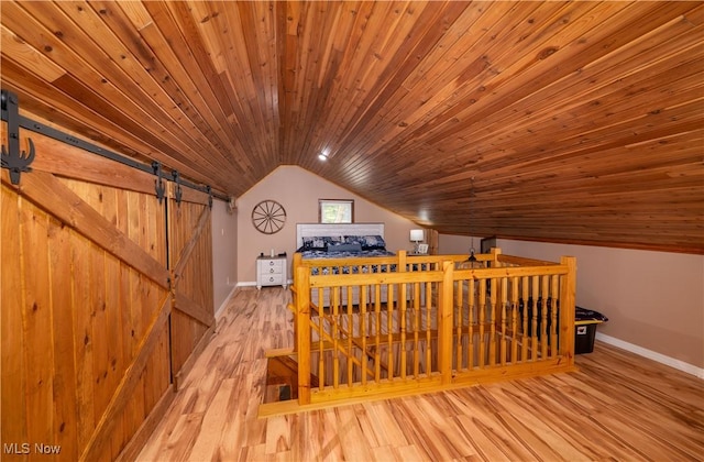 2461 Trailwood Dr SW, Carrollton, OH 44615 - additional living space featuring lofted ceiling, a barn door, wooden ceiling, and wood finished floors