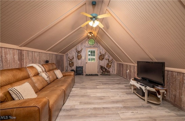 2461 Trailwood Dr SW, Carrollton, OH 44615 - living room featuring wooden walls, wood finished floors, vaulted ceiling, and ceiling fan