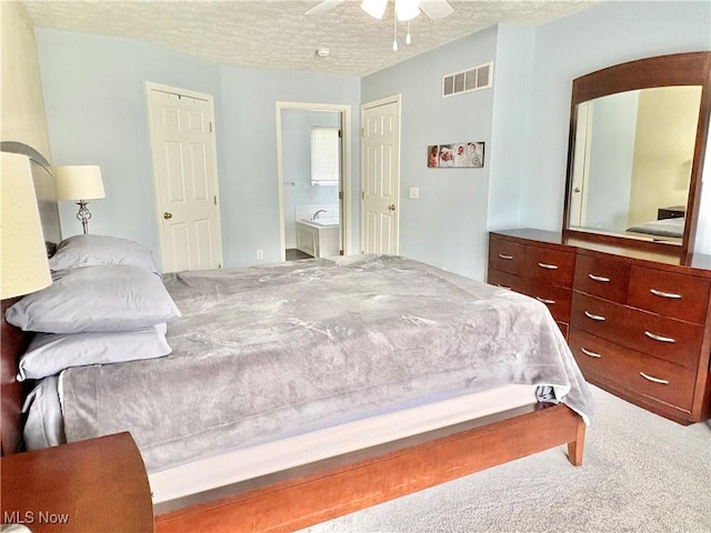 11208 Glen Abbey Dr, North Royalton, OH 44133 - carpeted bedroom with a textured ceiling, connected bathroom, and ceiling fan