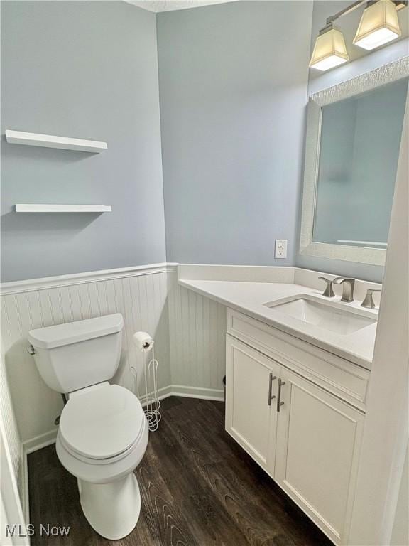 11208 Glen Abbey Dr, North Royalton, OH 44133 - bathroom with vanity, wainscoting, and wood finished floors