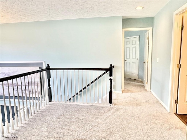 11208 Glen Abbey Dr, North Royalton, OH 44133 - hallway with an upstairs landing, carpet flooring, and a textured ceiling