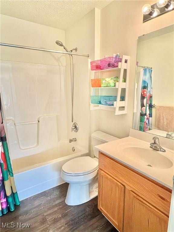 11208 Glen Abbey Dr, North Royalton, OH 44133 - bathroom with wood finished floors, shower / bathtub combination with curtain, vanity, and a textured ceiling