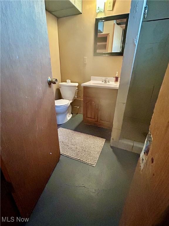 145 Marcia Dr, Austintown, OH 44515 - bathroom with concrete floors, vanity, and a walk in shower