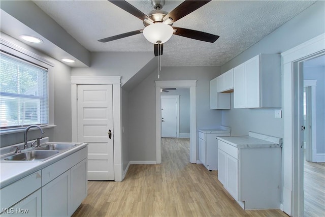 1213 Mckinley Ave, Akron, OH 44306 - kitchen featuring ceiling fan, white cabinetry, light wood-type flooring, and a textured ceiling