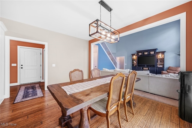 2940 Londonbury St NW, Uniontown, OH 44685 - dining space with wood-type flooring, stairs, and a chandelier