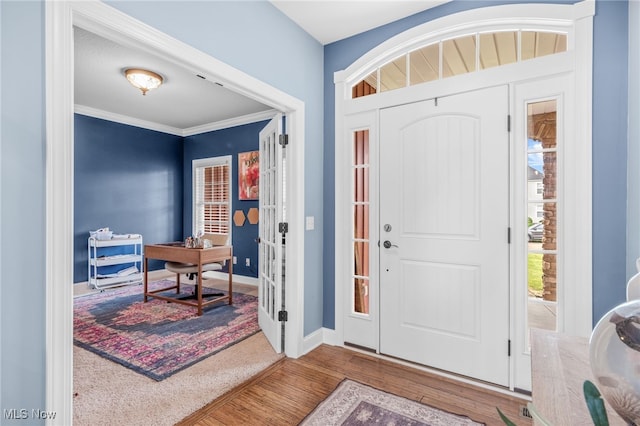 2940 Londonbury St NW, Uniontown, OH 44685 - entrance foyer featuring wood finished floors and crown molding