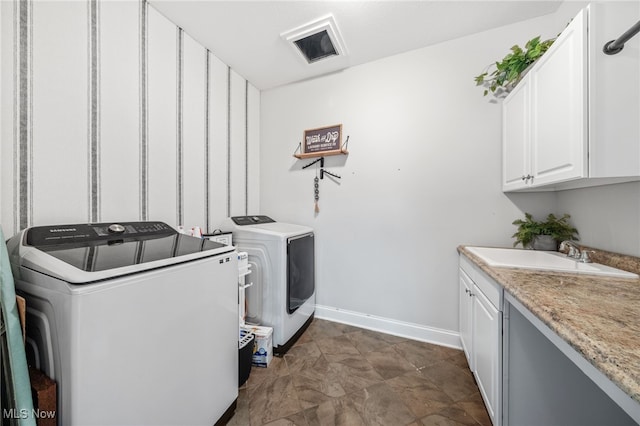 2940 Londonbury St NW, Uniontown, OH 44685 - washroom with cabinet space and washer and clothes dryer