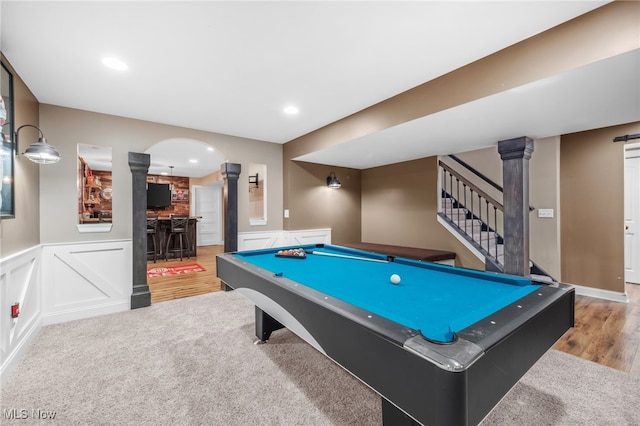 2940 Londonbury St NW, Uniontown, OH 44685 - recreation room with decorative columns, a decorative wall, billiards table, wainscoting, and wood finished floors