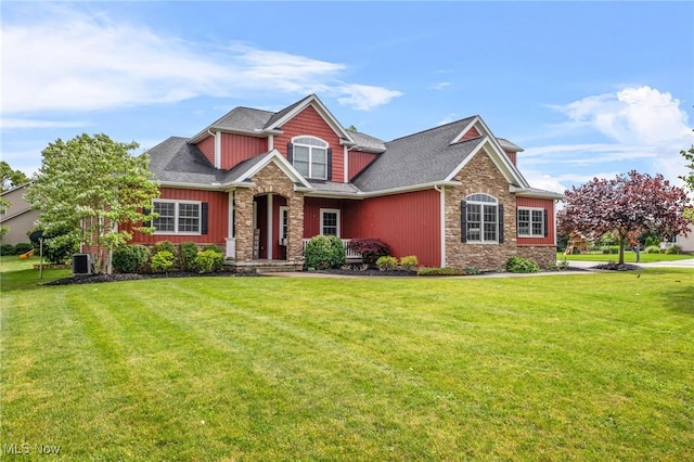 2940 Londonbury St NW, Uniontown, OH 44685 - craftsman house featuring stone siding and a front lawn
