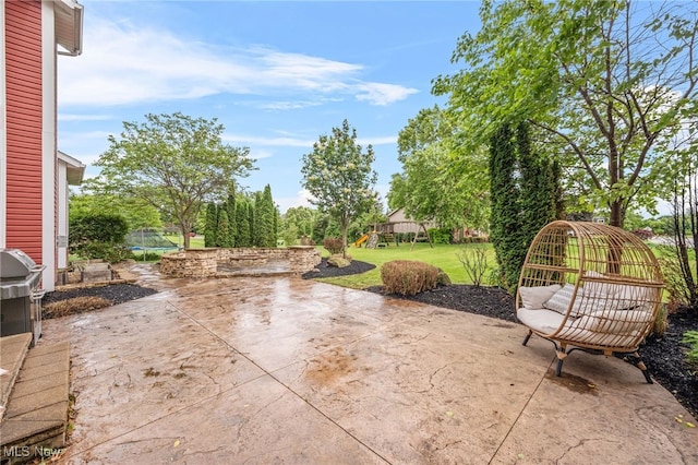 2940 Londonbury St NW, Uniontown, OH 44685 - view of patio with a trampoline and a grill