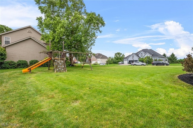 2940 Londonbury St NW, Uniontown, OH 44685 - view of grassy yard featuring a playground