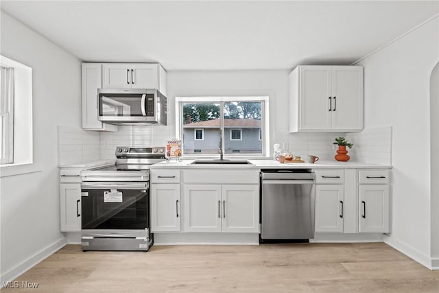 85 Pocantico Ave, Akron, OH 44312 - kitchen with stainless steel appliances, tasteful backsplash, white cabinetry, and light countertops