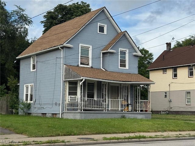 3569 Independence Rd, Cleveland, OH 44105 - view of front of property with a porch, roof with shingles, and a front lawn