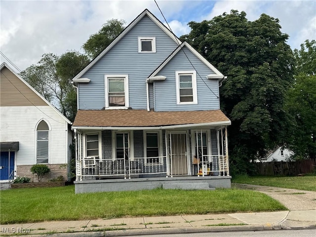 3569 Independence Rd, Cleveland, OH 44105 - view of front facade featuring a porch, a front lawn, and roof with shingles