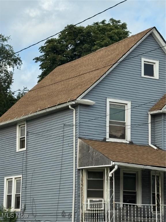3569 Independence Rd, Cleveland, OH 44105 - view of side of property with roof with shingles