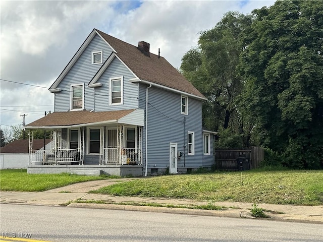 3569 Independence Rd, Cleveland, OH 44105 - view of front of home with covered porch, a chimney, and roof with shingles