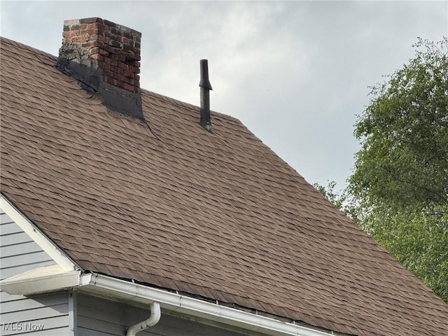 3569 Independence Rd, Cleveland, OH 44105 - exterior view of roof with shingles and a chimney