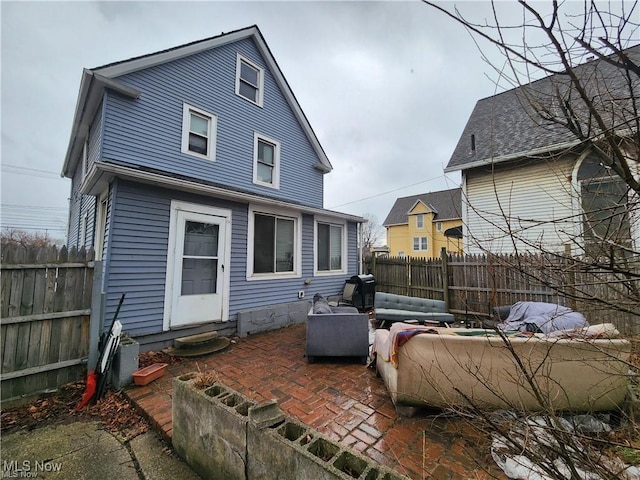 3569 Independence Rd, Cleveland, OH 44105 - rear view of house with entry steps, a patio, and a fenced backyard