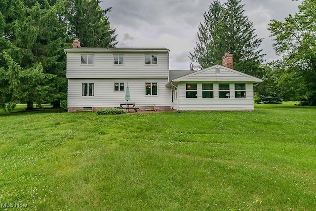 13228 Boulder, Chesterland, OH 44026 - back of property featuring a chimney and a lawn